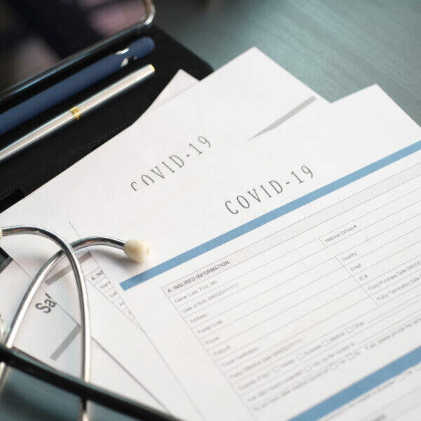 Coronavirus or COVID19  insurance policy document on desk, Health Care Insurance Plan concept.